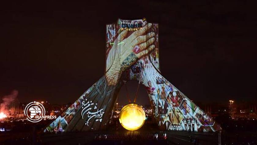 Iranpress: Tehran’s Azadi Tower glows on Islamic Revolution anniv