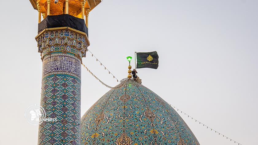 Iranpress: Mourning flag hoisted in Shah Cheragh on Muharram occasion