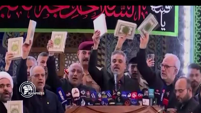 Iranpress: Holy Quran raised in ceremony of changing flag of Imam Hussain